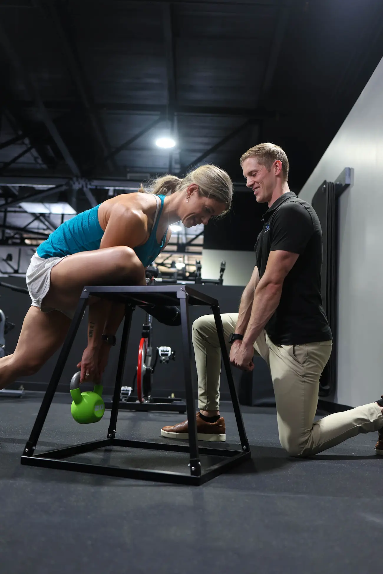 Dr. Wade helps a patient achieve proper form with a kettlebell exercise